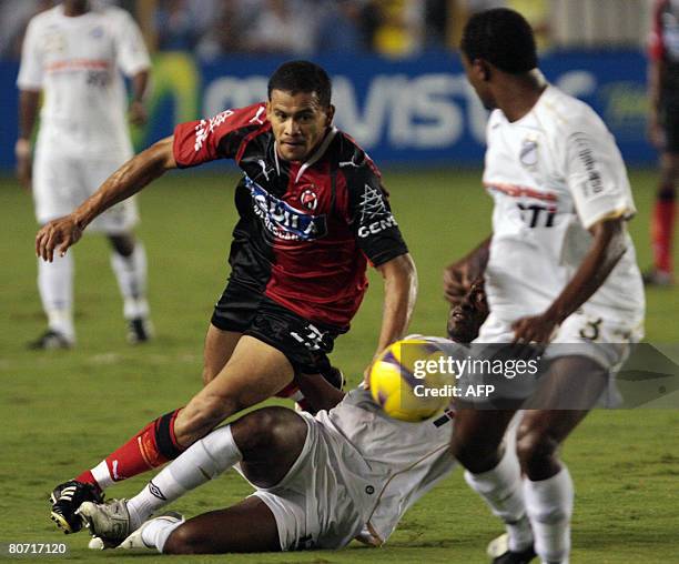 Colombian Cucuta' s player Leandro Abel Vargas vies for the ball with Fabao of Brazilian Santos during their Libertadores Cup football match at Vila...