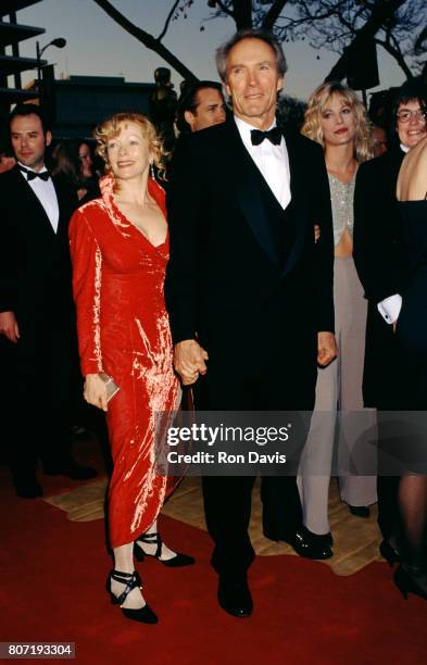 Actor Clint Eastwood and partner actress Frances Fisher attend the 66th Annual Academy Awards on March 21, 1994 at the Dorothy Chandler Pavilio, Los...