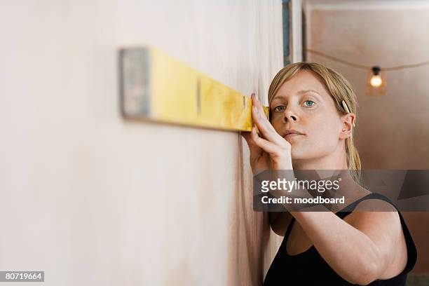 woman using level - spirit level stock pictures, royalty-free photos & images
