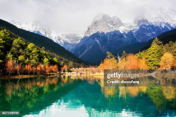 lake and snow mountain in autumn - yunnan province stock pictures, royalty-free photos & images