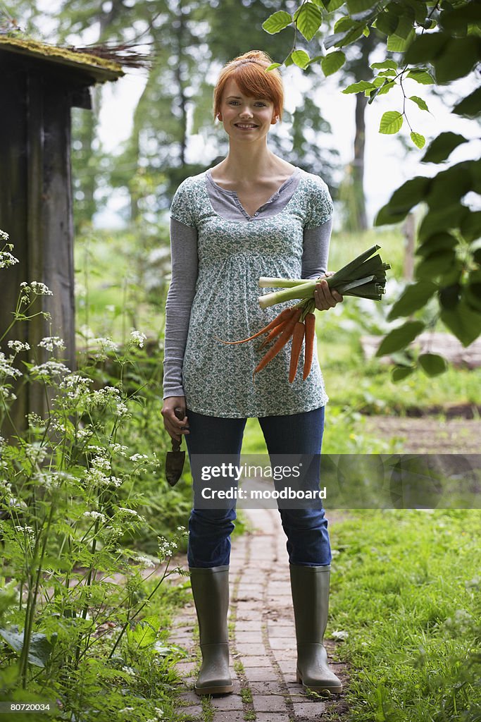 Woman Picking Vegetables in Garden