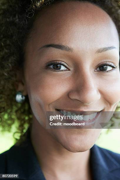 woman smiling outdoors close-up portrait - business revenge stock pictures, royalty-free photos & images