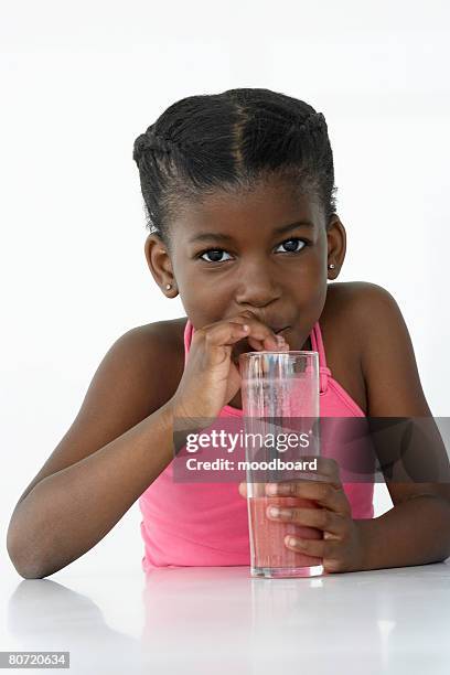 girl drinking fruit smoothie - african girl drinking water stockfoto's en -beelden