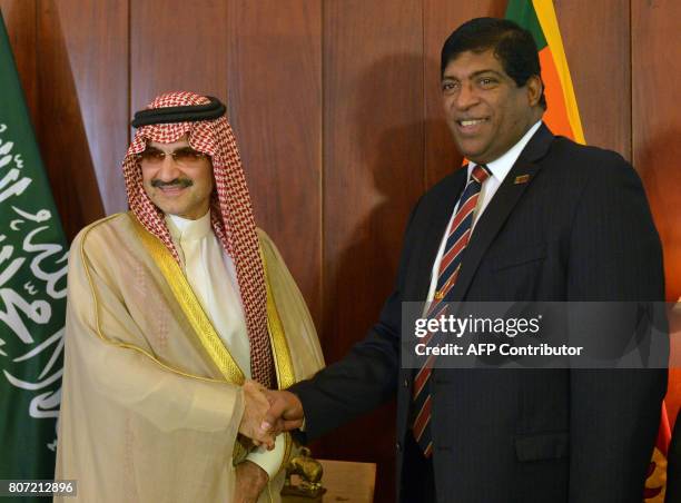 Saudi Arabian royal Al-Waleed Bin Talal bin Abdulaziz al Saud and Sri Lankan Foreign Minister Ravi Karunanayake shake hands ahead of a meeting in...