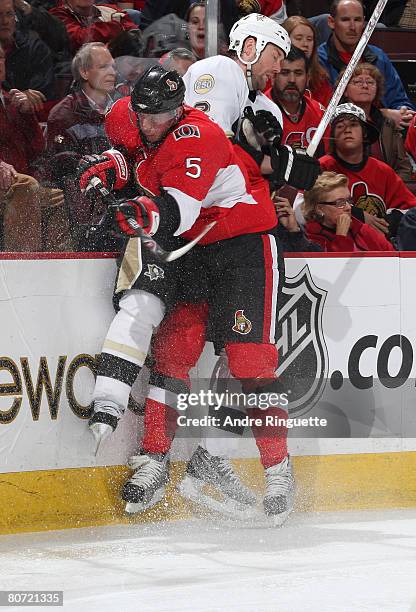 Christoph Schubert of the Ottawa Senators bodychecks Hal Gill of the Pittsburgh Penguins into the boards during game four of the 2008 NHL conference...