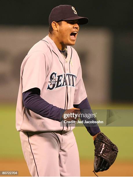 Felix Hernandez of the Seattle Mariners celebrates after striking out Mike Sweeney to the end the 8th inning against the Oakland Athletics during a...