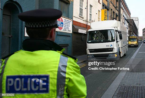 Prison van believed to contain the 17-year-old teenager accused of murdering schoolboy Rhys Jones arrives under police escort at Liverpool...