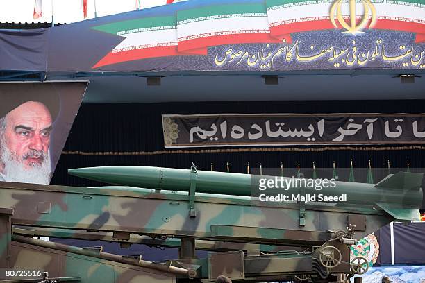 An Iranian surface to surface Zelzal missile is driven past portraits of Iran's late founder of the Islamic republic, Ayatollah Khomeini , during the...