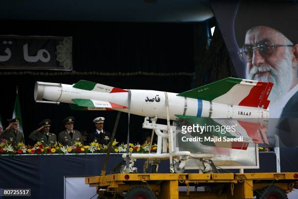An Iranian surface to surface Ghasedak missile is driven past portraits of Iran's late founder of the Islamic Republic, Ayatollah Ali khamenei ,...