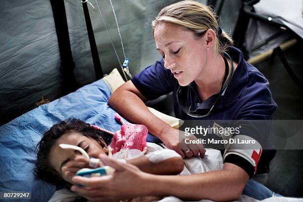 Welfare Officer Michelle McLaughlin of the Red Cross & St.John Defence Medical Welfare Service attends to Malalia as she recover in her hospital bed...