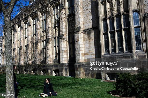 Woman sits on the grass on the campus of Yale University April 15, 2008 in New Haven, Connecticut. New Haven boasts many educational and cultural...