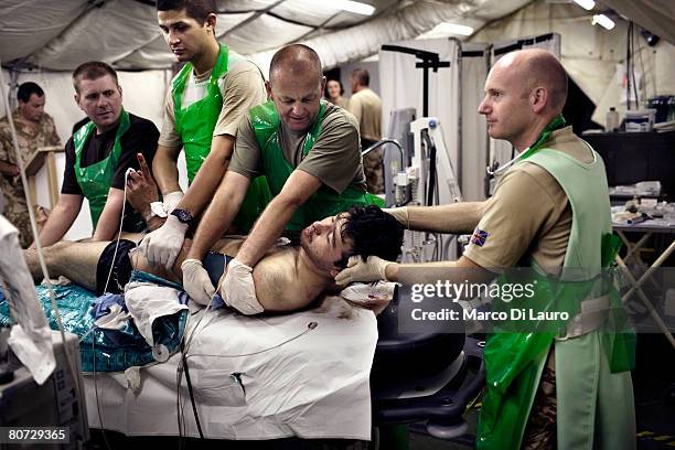 British military medical personnel from the UK Med Group load Afghan National Army soldier Bashir into a bed at the RESUS on June 8, 2007 at the...