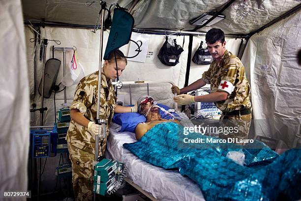 British Army nurses attend to British Army soldier Alexander Harrison from the Grenadier Guards Regiment attached to the Royal Anglion Regiment, at...
