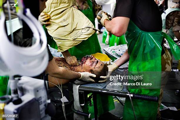 British military medical personnel from the UK Med Group perform an anaesthetic as part of a resuscitation on injured British Army soldier Simon...