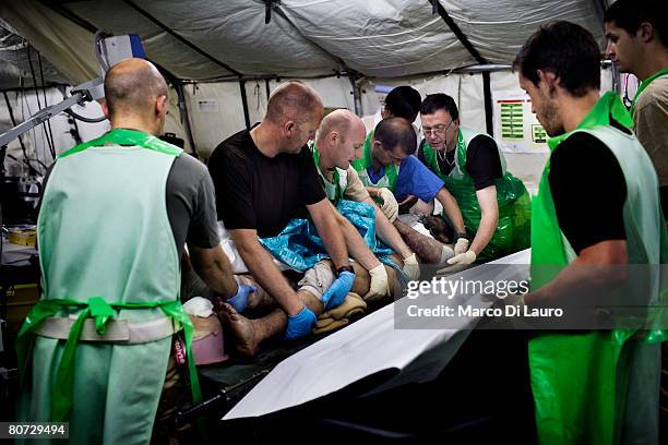 British military medical personnel from the UK Med Group load Afghan National Army soldier, Sgt. Quem Abdulh into a bed at the RESUS on June 11, 2007...