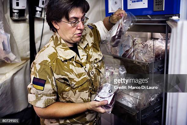 British Army Laboratories Technician Sgt. Janet Nicholson checks blood before issuing to the operating theatre at the hospital Laboratory on June 8,...