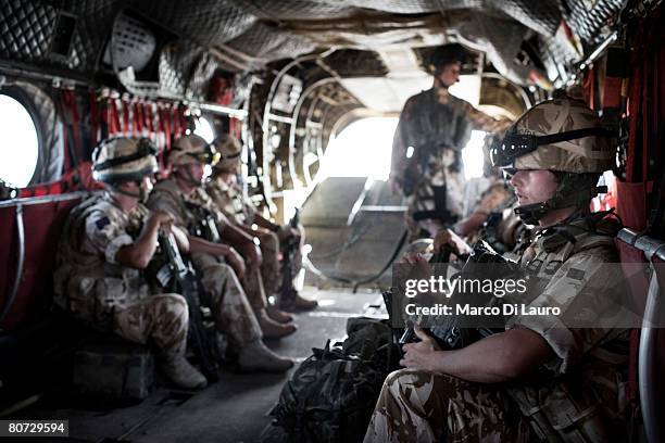 British Army soldiers from the Quick Reaction Force travel in the helicopter to protect the British Army Medical Emergency Response team from the UK...