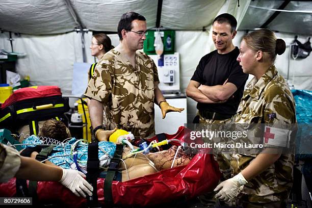 British Army Anaesthetist Lt. Col. Peter Mahoney ventilates British Army soldier Alexander Harrison from the Grenadier Guards Regiment attached to...