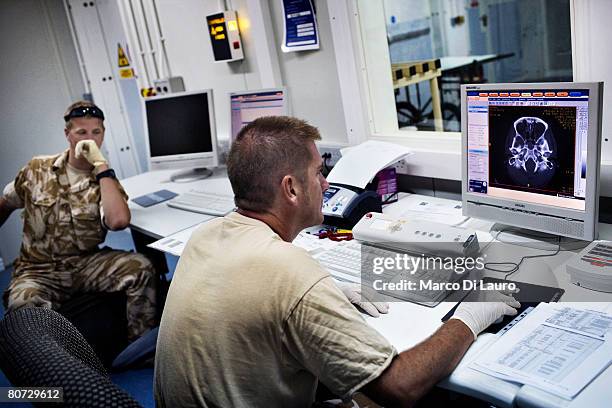 Royal Navy radiographer Chief Sean Ricks performs a CT scan on Afghan National Army soldier, Bashir on June 8, 2007 at the British Army Field...