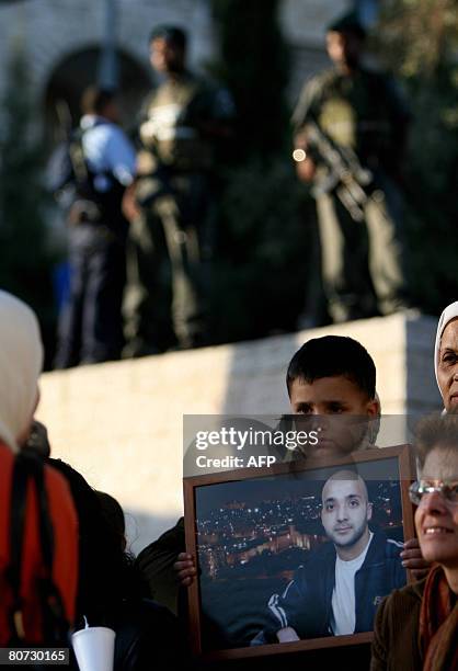 Israeli security forces stand guard as Palestinian women and children take part in a protest in honour of Prisoner's Day and more than 11,000...
