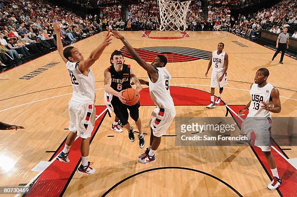 Zygimantas Janavicius of Team World goes to the basket against Drew Gordon and Tyreke Evans of Team USA during the Nike Hoop Summit on April 12, 2008...