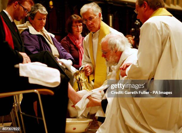 The Archbishop of Canterbury Dr Rowan Williams performs the Maundy Thursday feet washing ceremony accompanied by the Very Reverend Robert Willis,...