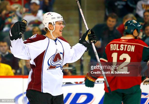 Paul Stastny of the Colorado Avalanche celebrates after scoring in the third period as Brian Rolston of the Minnesota Wild heads for the Minnesota...