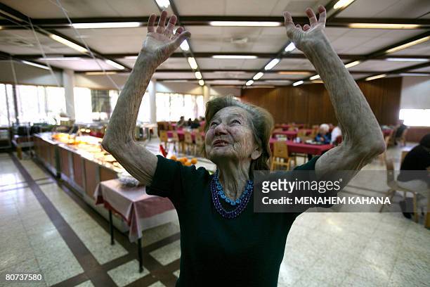 Riva Kippins gestures as she says: "My childhood was an elated paradise," during lunch at the cantine of Israel's oldest kibbutz, Deganya Alef, on...