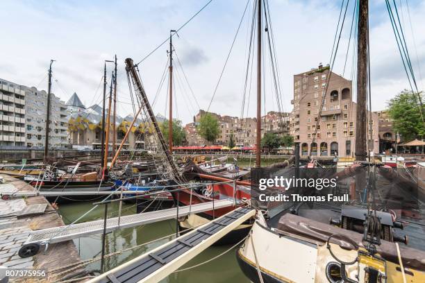 boats moored in the old docks with housing in rotterdam - nieuwe maas river stock pictures, royalty-free photos & images