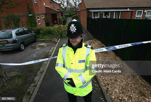 Police officers guard a cordon around houses in Comb Paddock in Westbury on Trym where a 19-year-old man was arrested under the Terrorism Act on...