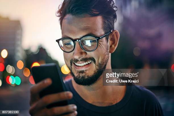 young man reading text message - photo call stock-fotos und bilder