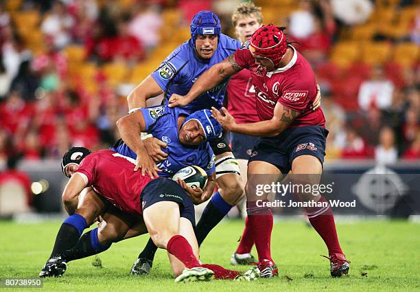 Tai McIsaac of the Force is tackled during the round ten Super 14 match between the Queensland Reds and the Western Force at Suncorp Stadium on April...