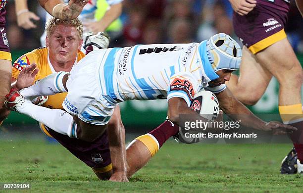 Preston Campbell of the Titans is tackled by Ben Hannant of the Broncos during the round six NRL match between the Gold Coast Titans and the Brisbane...