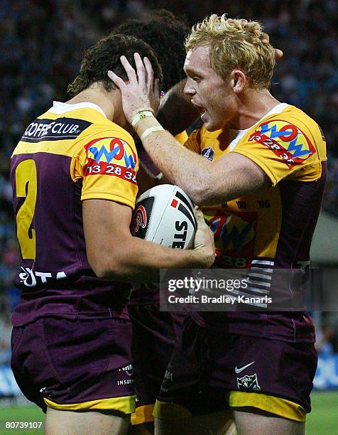 Deann Kemp of the Broncos is congratulated by Peter Wallace after scoring a try during the round six NRL match between the Gold Coast Titans and the...