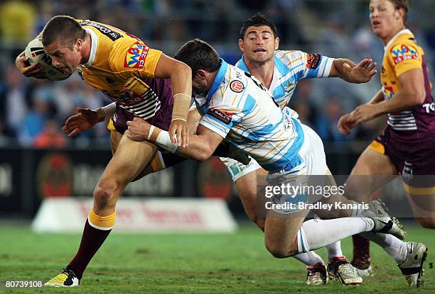 Ashton Sims of the Broncos attempts to break through the Titans defence during the round six NRL match between the Gold Coast Titans and the Brisbane...