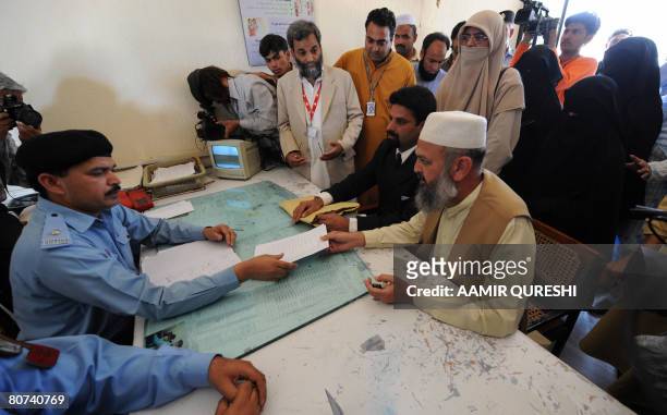Khalid Khawaja , a Pakistani rights activist hands an application to a local police official for the registration of a criminal case against...