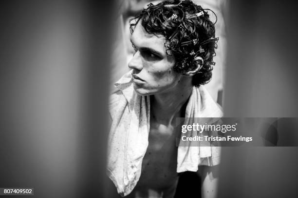 Image converted to black and white) A model is seen backstage ahead of the MSGM show during Milan Men's Fashion Week Spring/Summer 2018on June 18,...