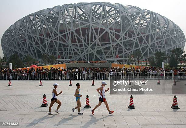 Athletes compete in the men's 20 km walk race during the 2008 BBMG IAAF Race Walking Challenge at the National Stadium, dubbed the Bird's Nest on...