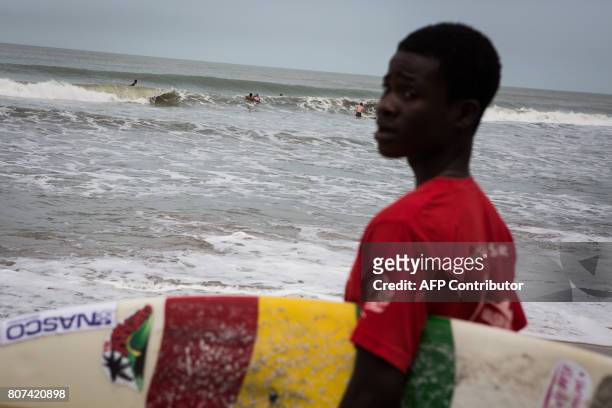 Surfers compete in the international surf day competition on Kokrobite Beach, Ghana, on June 18, 2017. The beach, some 30 kilometres west of central...