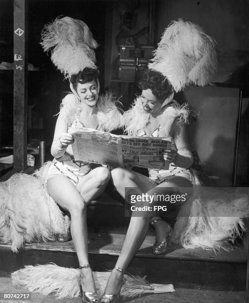 Showgirls Marion Swoyer and Mitze Mann read the Philadelphia Daily News between their turns on stage, 1949.