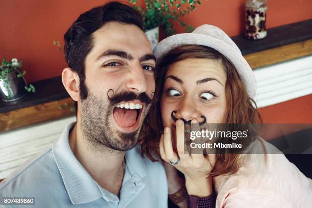 couple making crazy selfie - movember moustache stock pictures, royalty-free photos & images