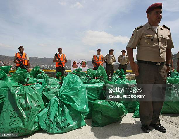 Venezuela's National Guard soldiers custody packages containing three tons of drugs to be incinerated at a military barracks in Caracas on April 18,...