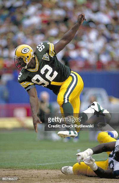 Green Bay Packers Defensive End, Reggie White, rushes the QB during a 1994 game against the Los Angeles rams at County Stadium in Milwaukee,...
