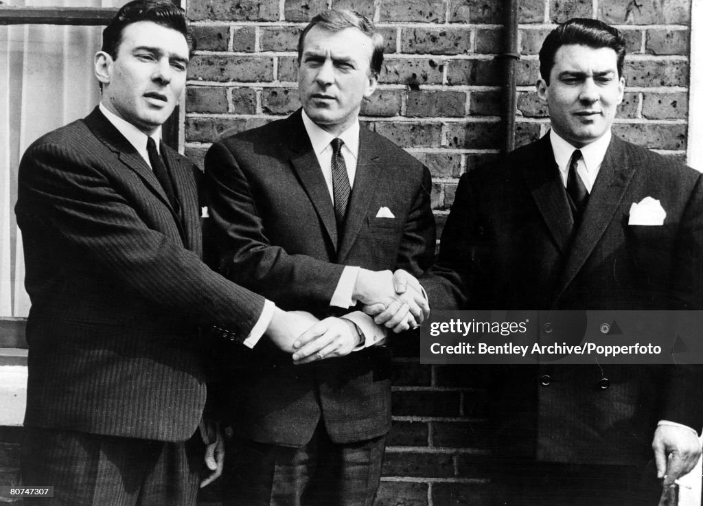 1960s East End London gangsters the Kray Brothers hold hands They are from left to right: Ronnie, Charlie, and Reggie.