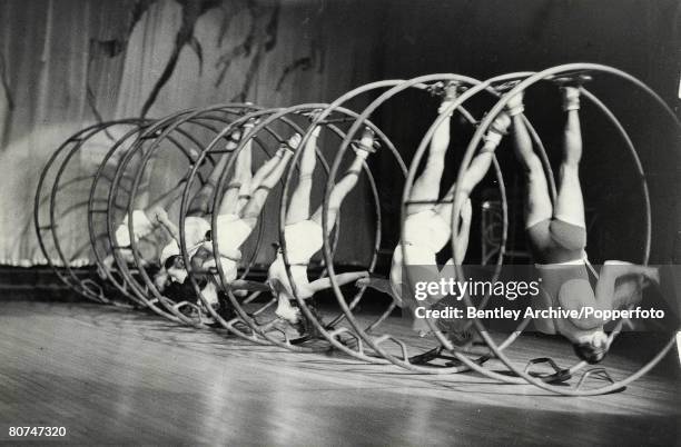 Classic Collection, Page 143 A group of dancers on stage, rolling along inside large hoops
