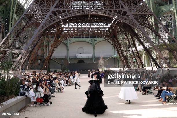 Models present creations for Chanel under a replica of the Eiffel Tower at the Grand Palais during the 2017-2018 fall/winter Haute Couture collection...