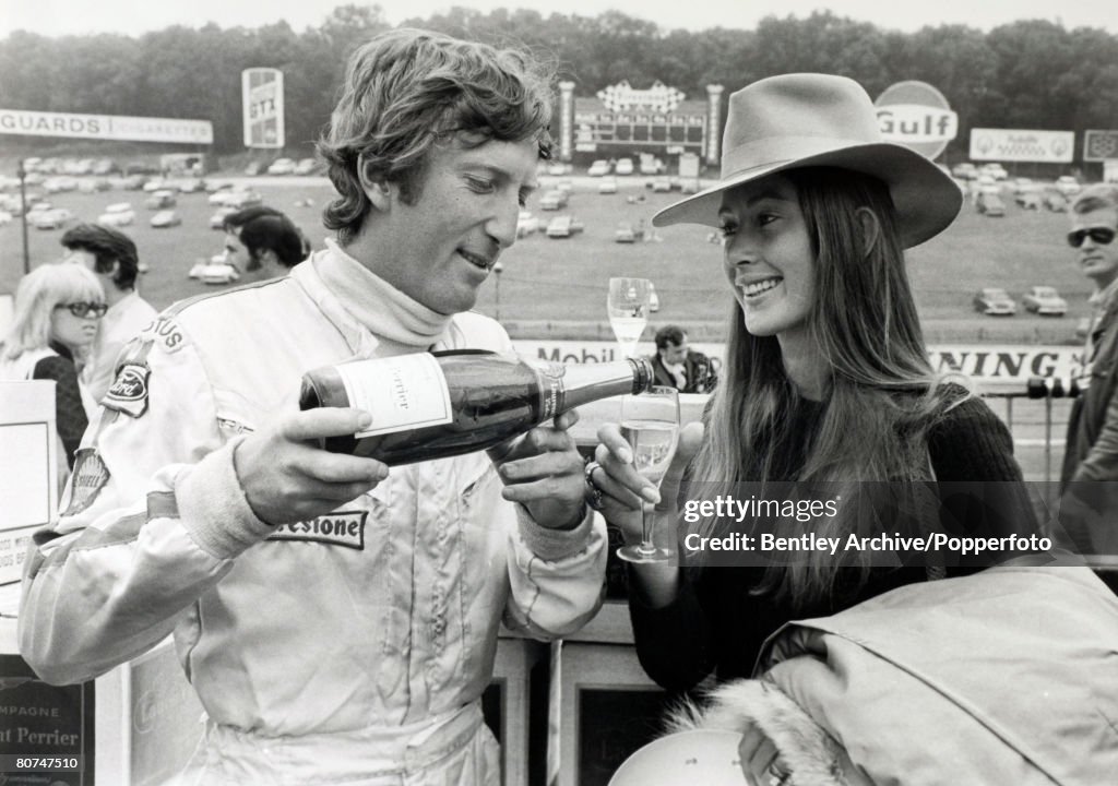 Sport Motor Racing. Formula One. 18th July 1970. British Grand Prix at Brands Hatch. The eventual winner of the British Grand Prix,1970, Austria's Jochen Rindt pours a glass of champagne for his wife Nina, after he had set a new lap record in the practic