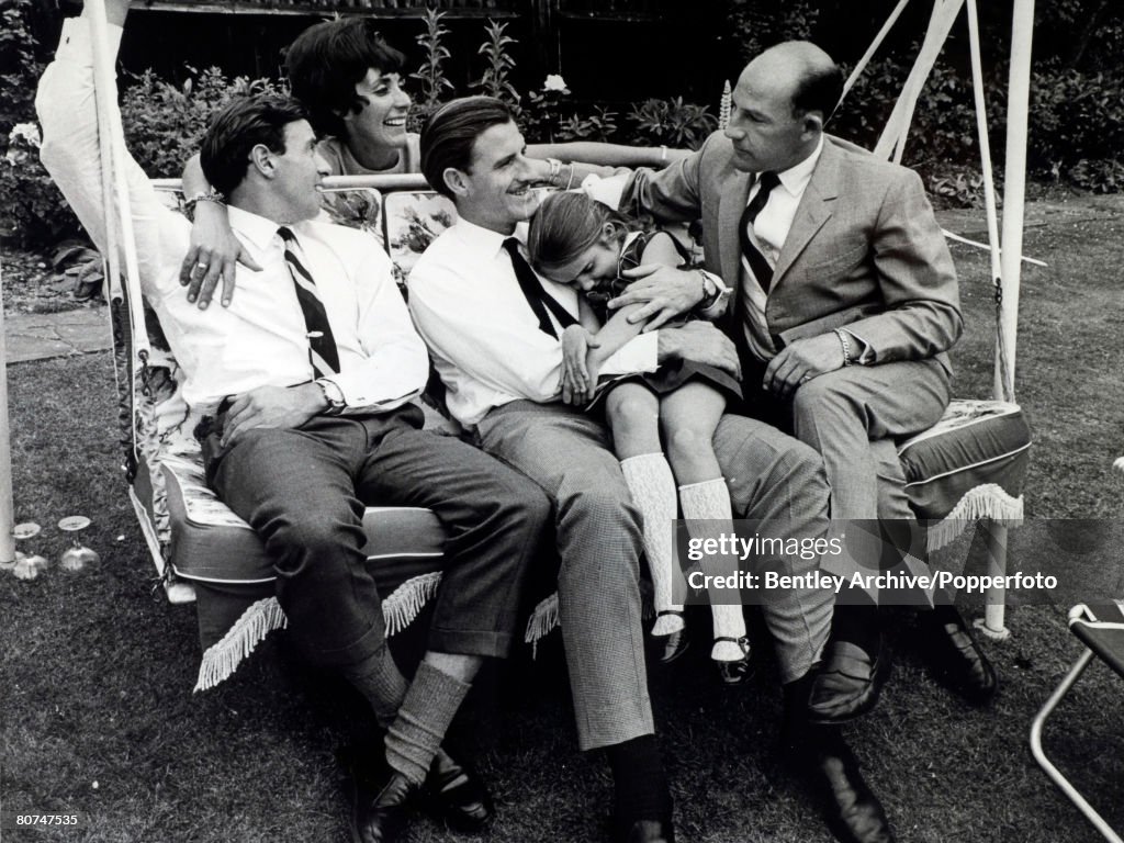 Sport Motor Racing. Formula One. pic: June 1966. British racing drivers get together Graham Hill, centre holds daughter Brigitte, Jim Clark, left, Mrs. Hill and Stirling Moss, right. Graham Hill was Formula One world champion twice in 1962 and 1968.