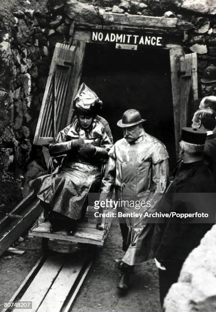 History Personalities, British Royalty, pic: May 1910, HM,Queen Mary pictured as she escorted from a coal mine entrance wearing protective clothing...