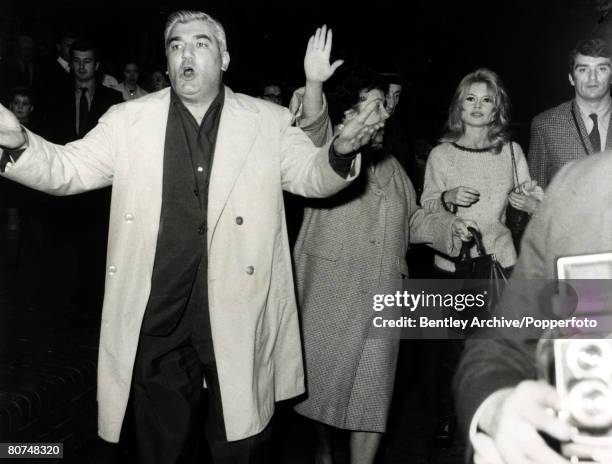 Cinema Personalities, pic: 27th October 1963, French film actress Brigitte Bardot, , pictured in London protected by an escort including arm waving...